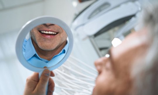 Periodontist examining a patient during a dental visit